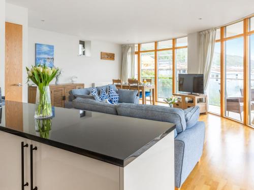 a kitchen and living room with a couch and a table at Apartment 22, Horizon View in Westward Ho