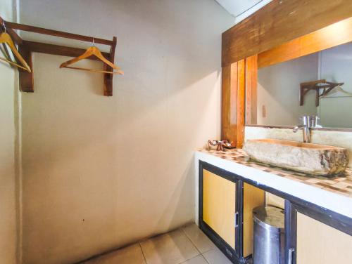 a bathroom with a sink and a mirror at The Lavana Green Asri Cottage in Senggigi