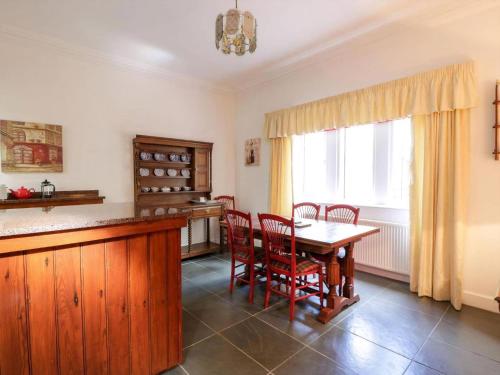 a kitchen with a table and chairs and a window at Gardeners- Uk7233 in Kirkmichael