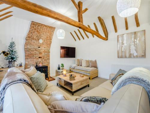 a living room with a couch and a table at The Retreat in Sudbrooke