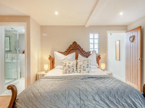 a bedroom with a large bed with pillows at The Cartlodge - Ukc1039 in Hickling