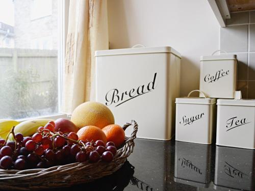 a basket of fruit on a counter next to a window at Meadow Mews in Chillington