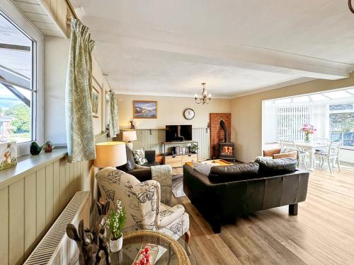 a living room with a couch and a table at Broadoak Barn in Ellesmere