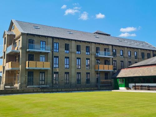 a large building with a lawn in front of it at Tilly's Den in Skipton