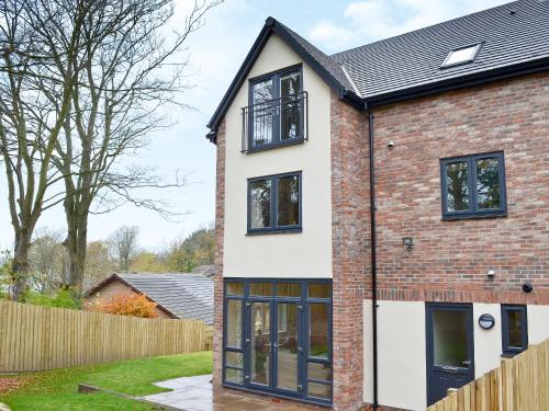 an extension to a brick house with black windows at Salar's Rest - 28028 in Alnmouth