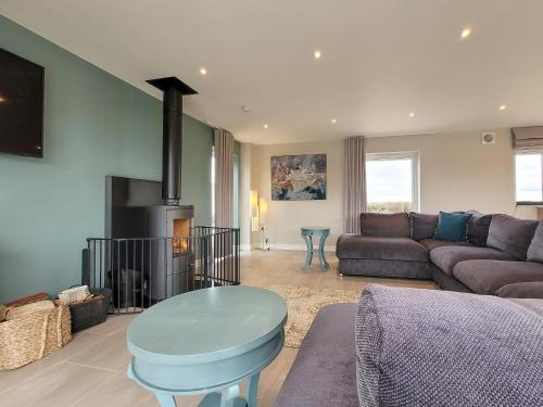 a living room with a couch and a fireplace at The Pines - Ukc4615 in Dunholme