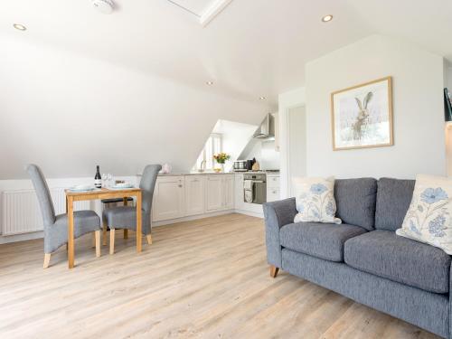a living room with a couch and a table at The Apple Loft in Mickleton