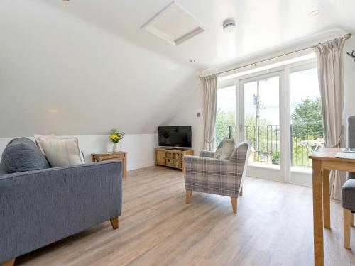 a living room with a couch and a tv at The Apple Loft in Mickleton