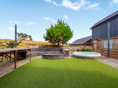 a backyard with a pool and green grass at The Grain Dryer in Gloucester