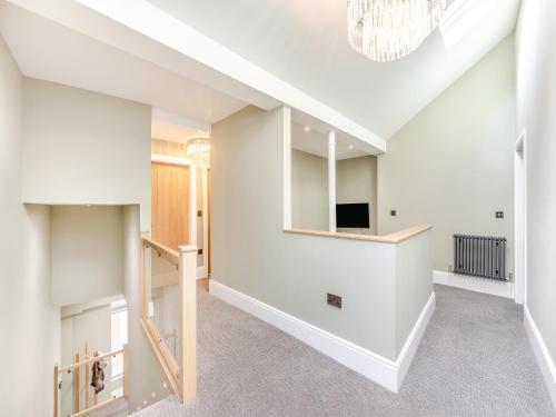 a living room with white walls and a ceiling at The Embassy in Eyemouth