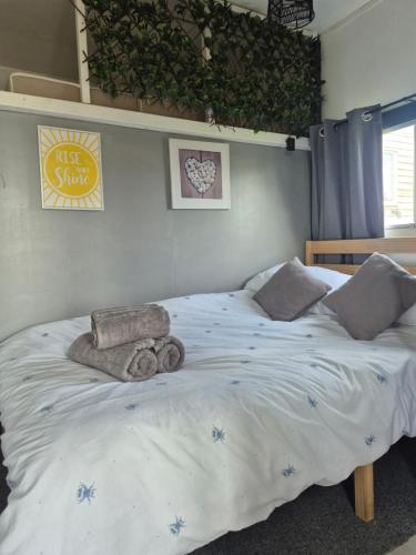 a bedroom with a bed with towels on it at The Paddock at Pioneer Billys in Camborne