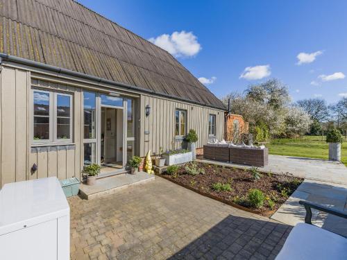 an exterior view of a house with a patio at Orchard Barn in Thurlton