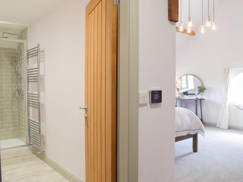 a room with a door leading to a bedroom at The Dairy - Uk34564 in Whitchurch