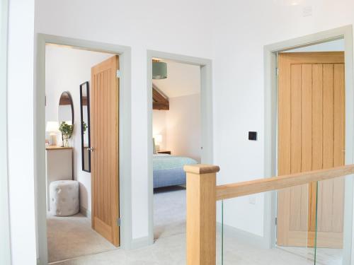a hallway with a door leading to a bedroom at The Dairy - Uk34564 in Whitchurch