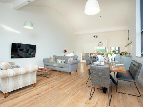 a living room with a table and chairs at Bluebell-Uk34613 in Nether Stowey