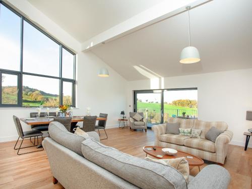 a living room with two couches and a table at Bluebell-Uk34613 in Nether Stowey