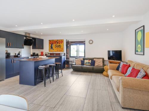 a living room and kitchen with a couch and a counter at Plough Share in Gloucester