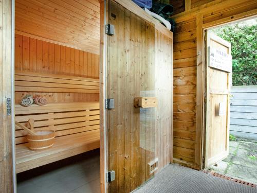 anoutside view of a wooden sauna with an open door at Uk45543-The Threshing Barn in Sticklepath
