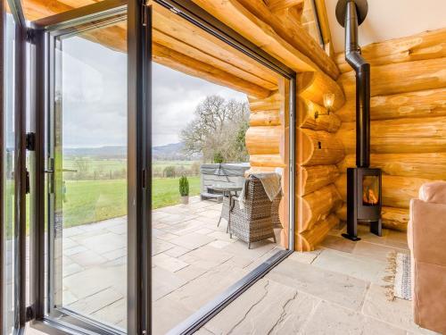 a sliding glass door leading to a patio with a grill at Hope Hideaway in Buttington