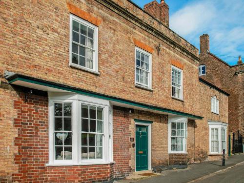 a brick building with a green door on a street at Brook House - Uk43013 in Berkeley