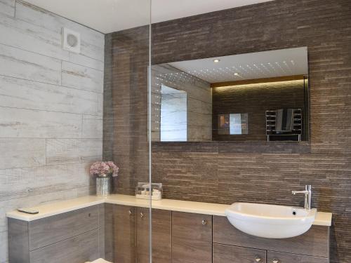a bathroom with a sink and a mirror at Hillend Stables in Dalry