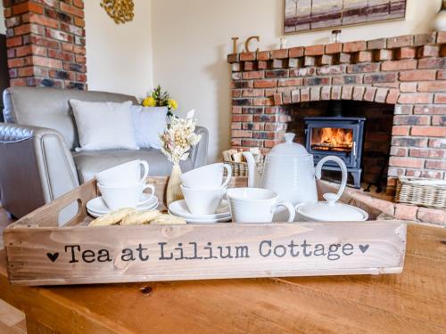 a coffee table with a tea tea at kilimanjaro cottage at Lilium Cottage in North Somercotes