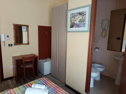 a small bathroom with a toilet and a sink at HOTEL GIORDANA in Loano