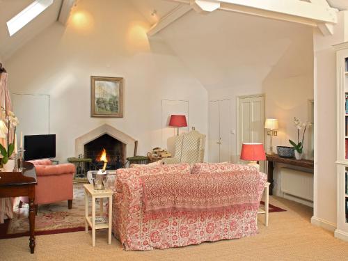 a living room with a bed and a fireplace at Cope - Ukc1145 in Bruern