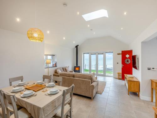 a living room with a table and a couch at Y Beudy Gwydir in Trevor