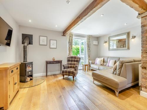 a living room with a couch and a fireplace at The Lilac-Uk47149 in Burgh le Marsh
