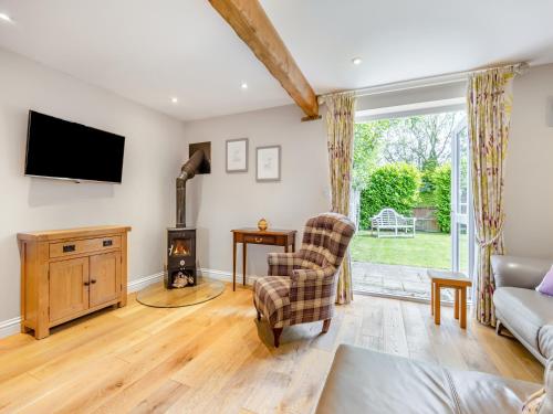 a living room with a tv and a couch at The Lilac-Uk47149 in Burgh le Marsh