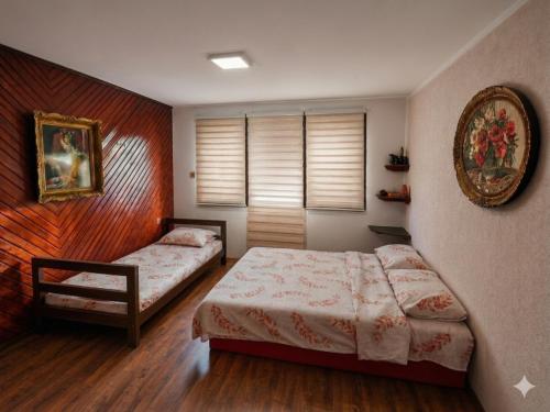 a bedroom with two beds and a window at KOPILOVE in Foča