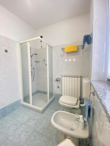 a bathroom with a shower and a toilet and a sink at VerdeLago casa vacanze in Luino