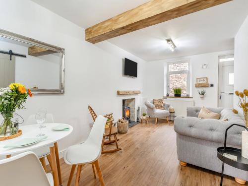 a living room with a couch and a table at Wick Cottage in Nottage