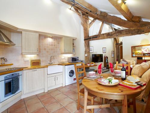 a kitchen with a wooden table in a room at Bramble Cottage - Uk4186 in Hazlehead Bridge