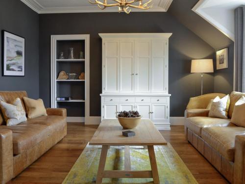 a living room with a couch and a table at Darroch View in Ballater