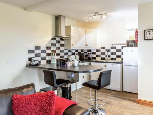 a kitchen with a table and chairs in a room at Hall Farm Cottage in Byers Green