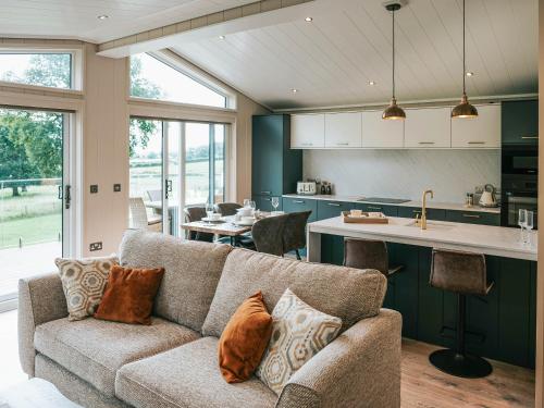 a living room with a couch and a kitchen at Rue - Uk51100 in Clitheroe