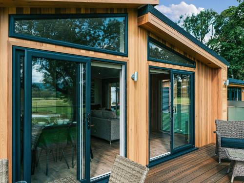 a house with glass doors on a deck at Rue - Uk51100 in Clitheroe