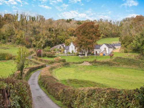 a house on a hill with a dirt road at Y-Beudy Bach - Uk51421 in Llandeilo