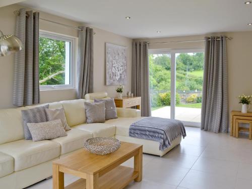 a living room with a couch and a table at Honey Pippin in Cheriton Bishop