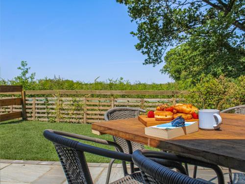 a wooden table with a bunch of food on it at No 2 Badger Sett-Uk44307 in Lenwade