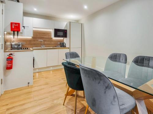 a dining room with a table and chairs and a kitchen at Uk47852 - No 1B in Aberystwyth