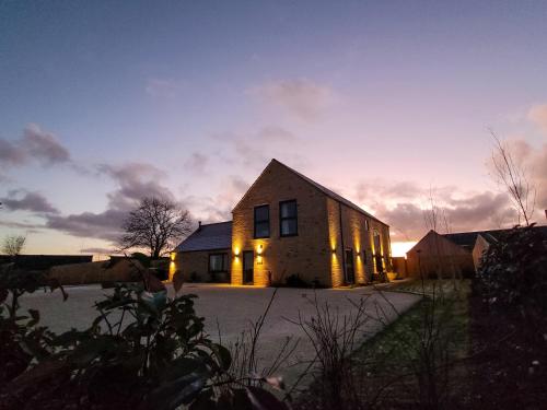 a large brick building with the lights on at The Willows - Ukc4617 in Dunholme