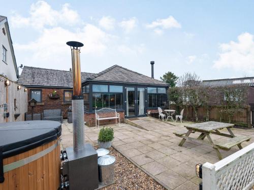 a patio with a grill and a picnic table at Greenbank Farm in Weeton