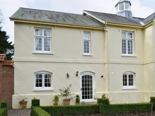 a white house with white windows at Garden Cottage in Westleigh