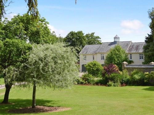 a house with a tree in the yard at Garden Cottage in Westleigh