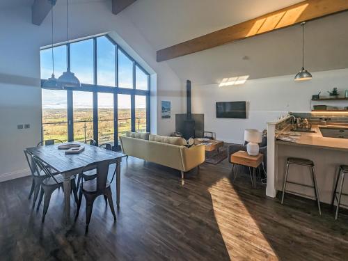 a living room with a couch and a table at The Barn At Toft Hill Hall in High Etherley