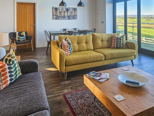 a living room with a couch and a table at The Barn At Toft Hill Hall in High Etherley