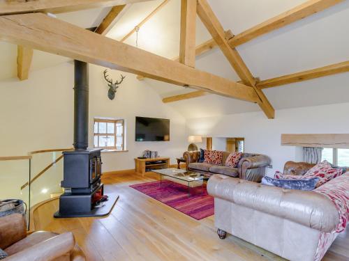 a living room with a wood stove in a house at Mungeon Barn - Uk30125 in Backbarrow